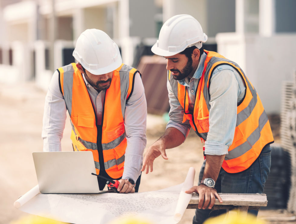 Building and construction project manager and architect on site discussing building project